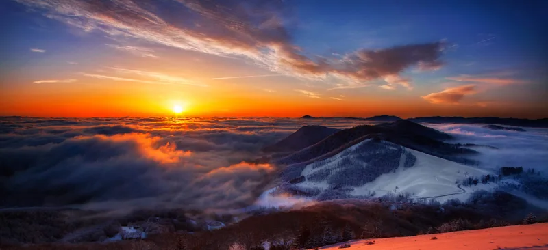 Snow-covered Cataloochee slopes above fog-filled valleys at sunrise